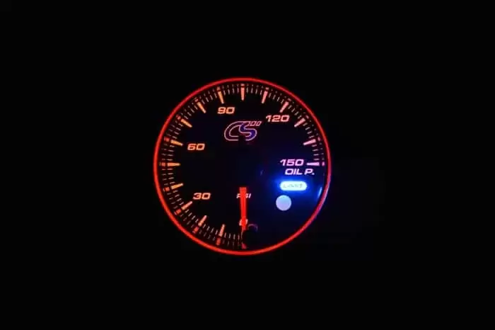 Orange face Mazdaspeed oil pressure gauge with warning.