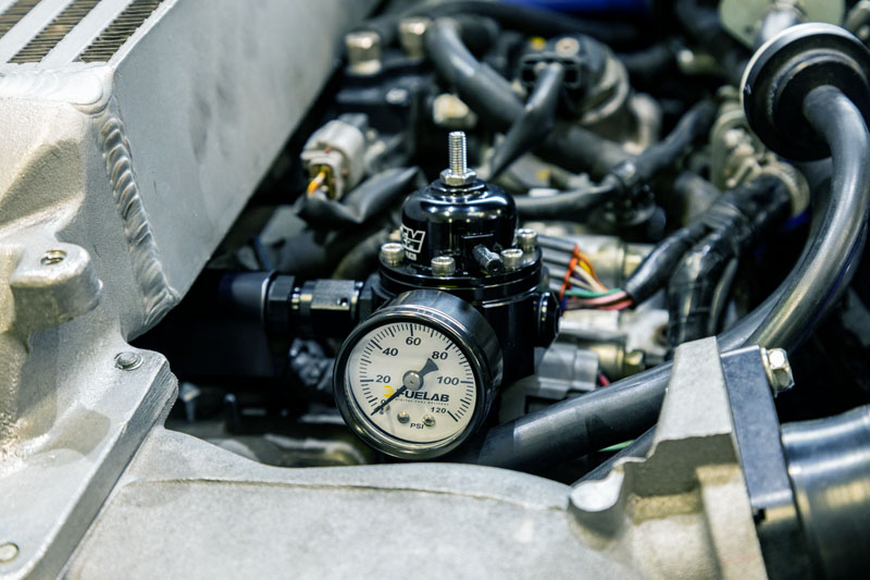 Return style fuel system increases fuel pressure with boost pressure to maintain a consistent fuel supply.