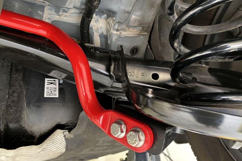 Close up of red sway bar installed on AWD Mazda