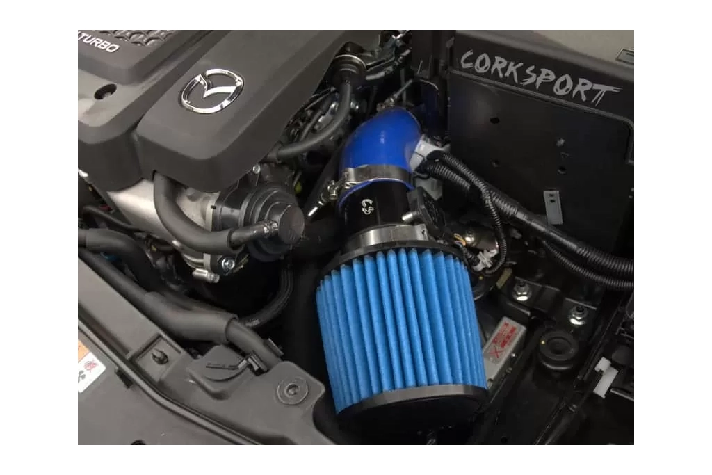 Blue silicone and filter shown with the black powder coated turbo inlet pipe and polished clamps installed on a Mazdaspeed6