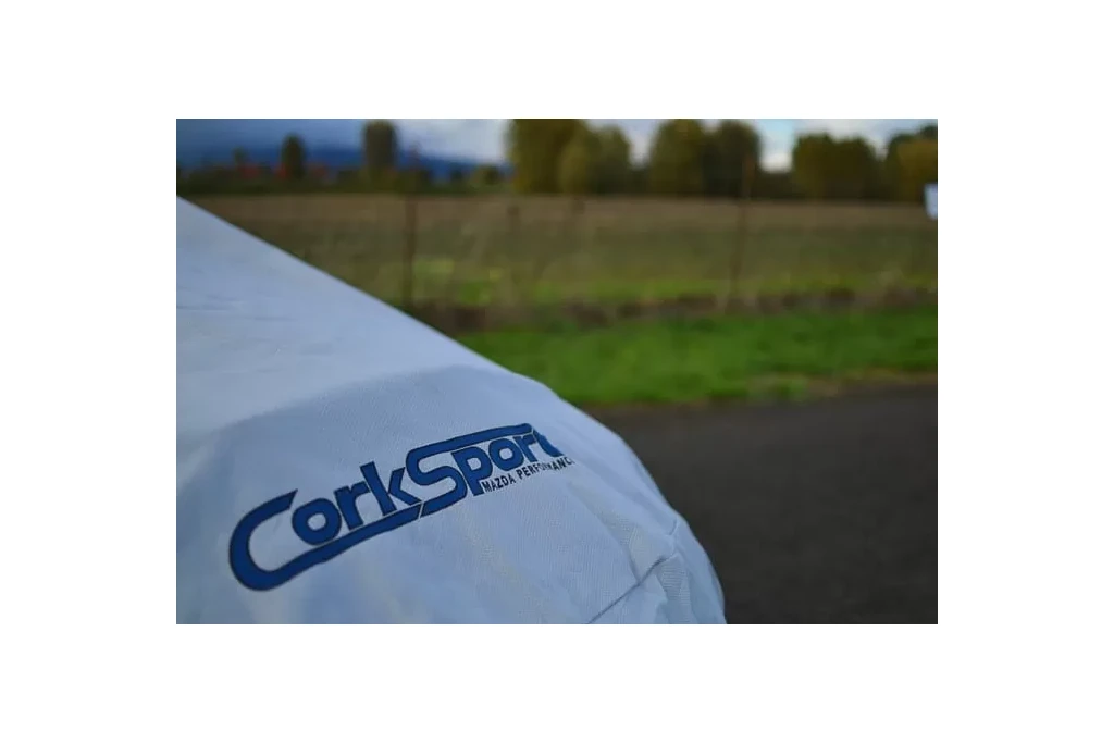 The car cover features a stylish screen printed logo