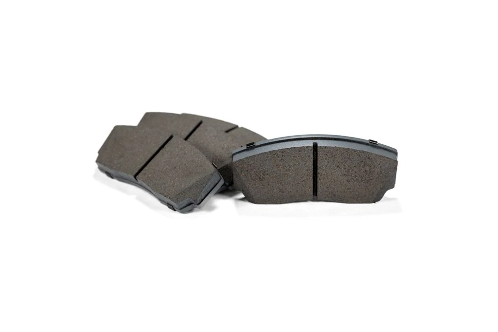 Set of 4 mazda performance brake pads which include the backer.