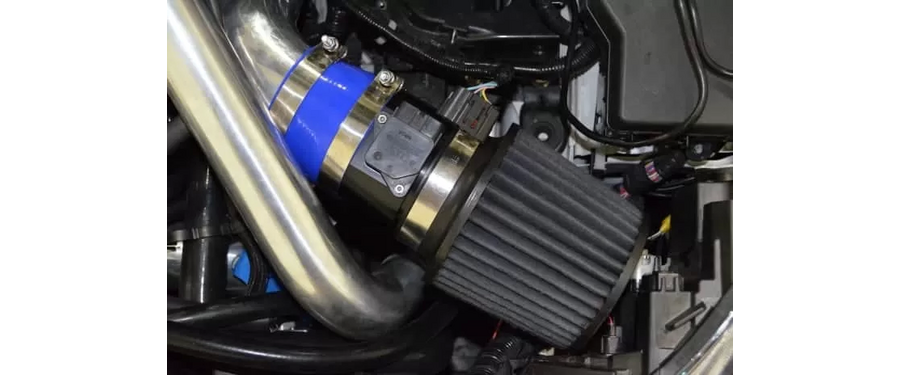A close up view of the 3.5" intake system in the engine bay of a 2010-2013 Mazdaspeed 3.