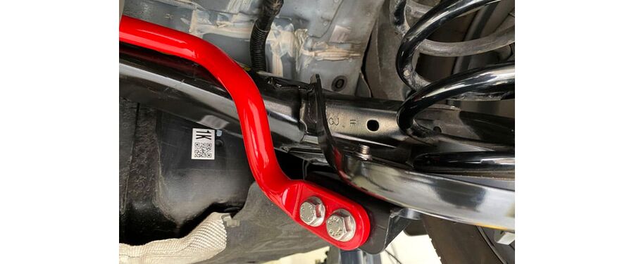Close up of red sway bar installed on AWD Mazda
